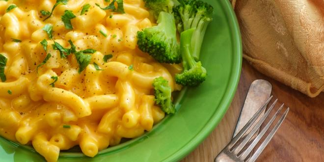 a plate of cheesy macaroni with broccoli